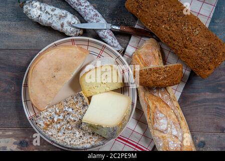 cheeses, sausage and Tomme de Savoie, Savoy, the french Alps France. Stock Photo