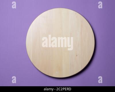 Empty wooden round tray on lilac background Stock Photo