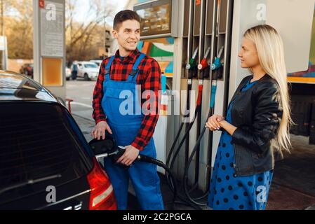 Male worker and woman fuels vehicle on gas station Stock Photo - Alamy
