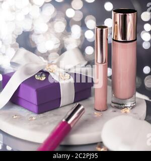 Holiday make-up foundation base, concealer and purple gift box, luxury cosmetics present and blank label products for beauty bra Stock Photo