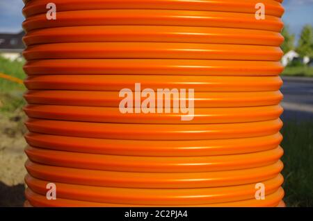 A roll of orange cables. Construction of optical fiber installation. Stock Photo
