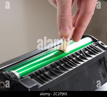 Technician hand cleaning printer toner cartridge Stock Photo