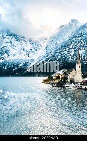 Viewpoint of Hallstatt old town city snow mountains and lake with reflection in the water in Winter season landscape portrait Hallstatt, Austria Stock Photo