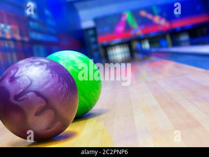 Balls on bowling alley against ten pins Stock Photo