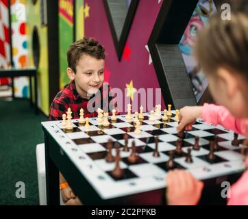 Little kids playing chess in entertainment center. Happy childhood. Adventure time Stock Photo