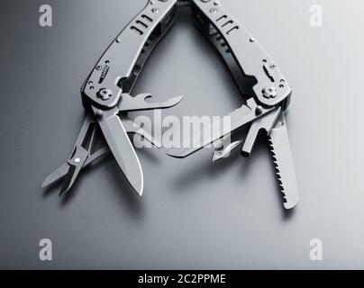 Black opened multitool knife with various tools Stock Photo