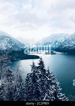 Scenery of Hallstatt Winter snow mountain landscape valley and lake through the forest in upland valley leads to the old salt mine of Hallstatt, Austr Stock Photo