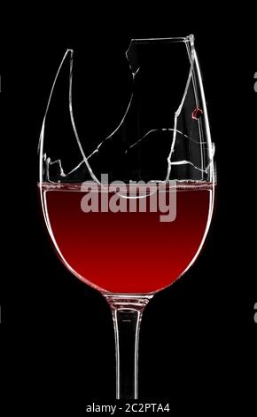 Broken glass of red wine isolated on black Stock Photo