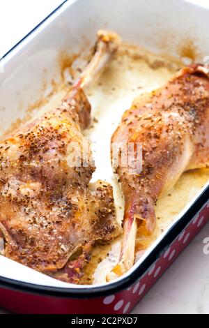 baked goose legs with cumin in frying pan Stock Photo