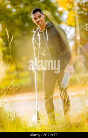 Smiling volunteer conserving environment from pollution and plastic Stock Photo