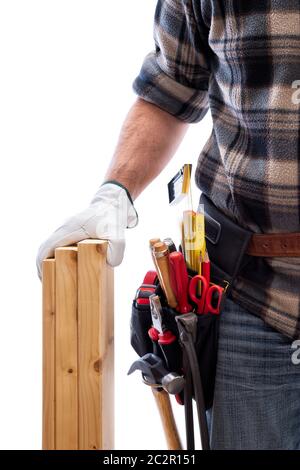 Carpenter isolated on a white background; he wears leather work gloves, he is holding wooden boards. Work tools industry construction and do it yourse Stock Photo