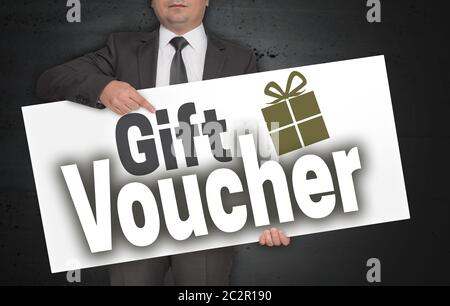 Gift Voucher poster is held by businessman. Stock Photo