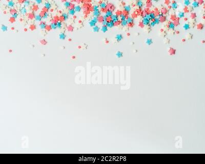 Festive border frame of colorful pastel sprinkles on pink background, copy  space top. Sugar sprinkle dots and stars, decoration for cake and bakery. T  Stock Photo - Alamy