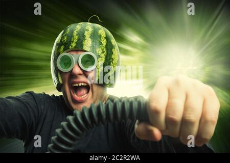 Bizarre man in a helmet from a watermelon riding fast Stock Photo
