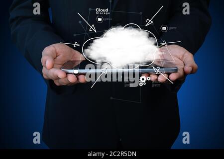businessman holding cloud network icon on tablet computer Stock Photo