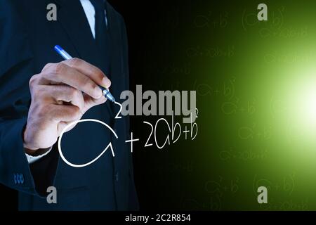 Man writing the mathematical equations Stock Photo