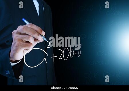 Man writing the mathematical equations Stock Photo