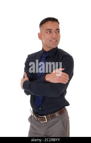 A handsome east Indian business man standing in the studio isolated over white background, in a black shirt with his arms crossed Stock Photo