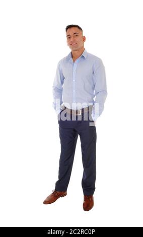 A handsome east Indian man standing in dress pants and a blue shirt relaxed in the studio, smiling, isolated for white background Stock Photo