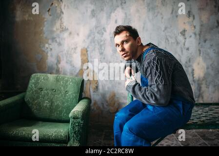 Crasy man in uniform with plasters on the face, psycho patient. Mentally ill people concept, madman Stock Photo