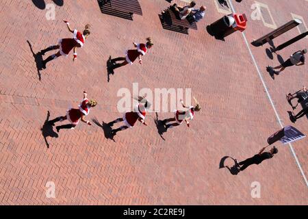 Santa ‘flash mob’ performs at Darling Harbour, Sydney to promote Santa Fest 2013. Stock Photo