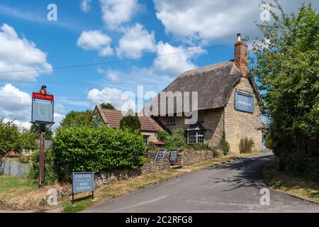 The Red Lion, a pretty thatched country pub, in the village of Yardley Hastings, Northamptonshire, UK Stock Photo