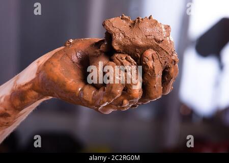 raw clay in the hands of women Stock Photo