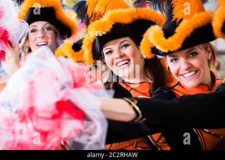 Cheerful German traditional dance group Funkenmariechen in carnival celebration Stock Photo