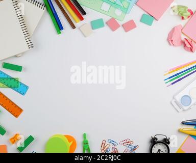 school supplies: multicolored wooden pencils, paper stickers, paper clips, pencil sharpener, copy space Stock Photo