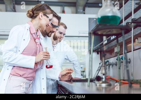 Group of chemical scientists working in the laboratory Stock Photo