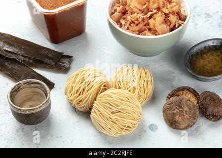 Ramen ingredients. Dried sea vegetable kelp, soba noodles, dashi, tuna flakes, shiitake mushrooms, sake, red miso paste, mirin Stock Photo