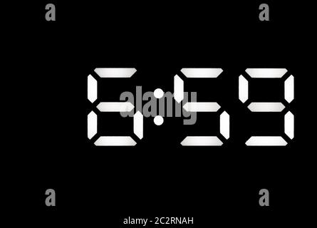 Real white led digital clock on a black background showing time 6:59 Stock Photo