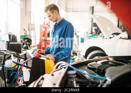 Mechanic checks air conditioning system in car. Conditioner inspection, diagnostic Stock Photo