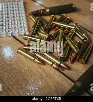 17HMR and .308 Ammunition on board surrounded by powder Stock Photo