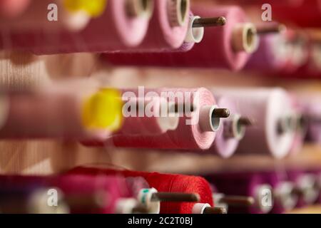 Colorful cotton thread rolls for sewing machine. thread spools for garment industry Stock Photo