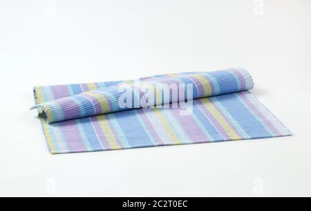 Colorful striped ribbed woven cotton place mat - folded Stock Photo