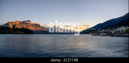 Panorama of Queenstown, Lake Wakatipu and The Remarkables mountain ranges at sunset Stock Photo