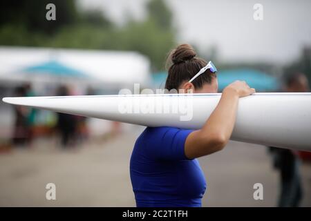 Details with the hand of a female professional rower carrying a kayak. Stock Photo