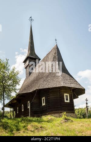 A typical wooden village church with its shingle roof, Maramures, Romania Stock Photo