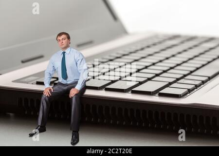 A man sitting on laptop thinks Stock Photo