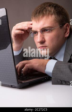 A young office worker working till late Stock Photo