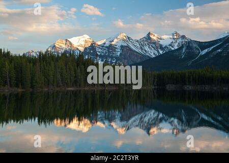 Wonderful reflections on water of Herbert lake at sunset, along Icefield Parkway, Banff National Park, Alberta, Canada Stock Photo