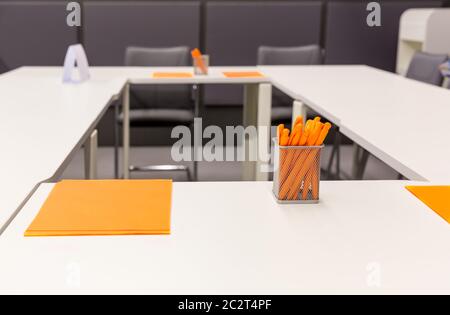 Modern office with orange pens and papers Stock Photo