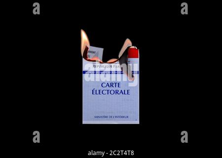 Burning official french electoral voter card symbolizing protest and subversion, isolated on black background. Stock Photo