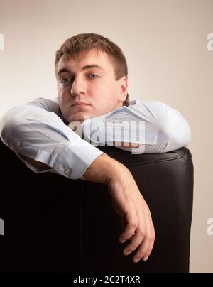 Tired office worker in a suit staring pensively Stock Photo