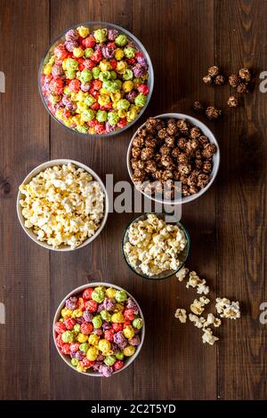 Colorful popcorn in bowl on white background top view Stock Photo