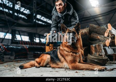 Stalker and dog, friends in post apocalyptic world. Post-apocalypse lifestyle on ruins, doomsday, judgment day Stock Photo