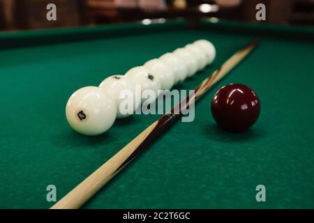 Billiard balls and pool sticks on the green table Stock Photo