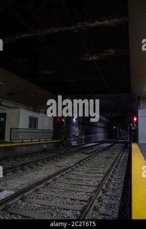 Empty underground train tunnel. Dark subway station. Malaga, Spain - March 3, 2020. Stock Photo