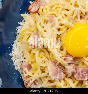 carbonara paste in a blue plate. national italian dish Stock Photo